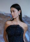 model wearing navy jacquard dress with fresh baroque pearl stud earrings